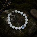 Cat's-eye aquamarine and silver bead bracelet on slate