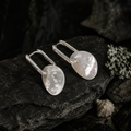Pair of organic white shell earrings on slate