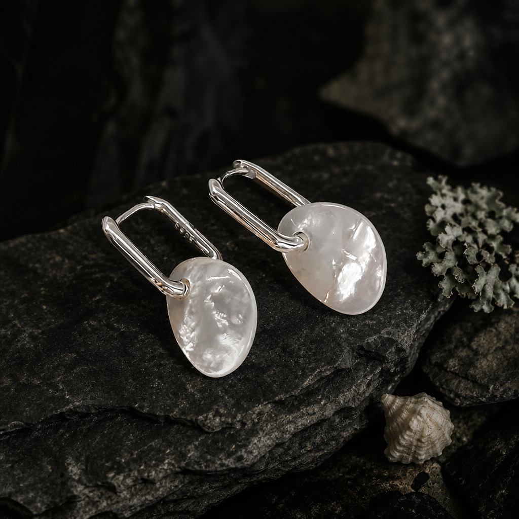 Pair of organic white shell earrings on slate